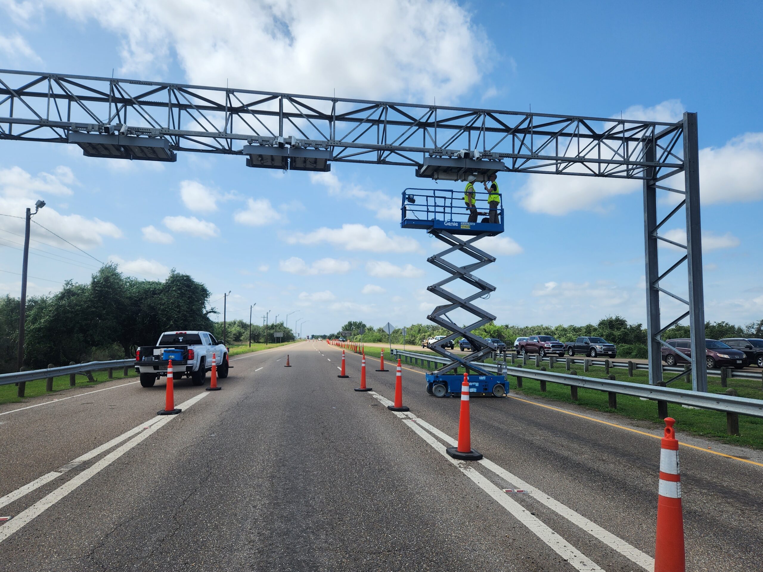 PSI field-service team installing LANCER™ neutron detectors on a custom gantry over a US highway.